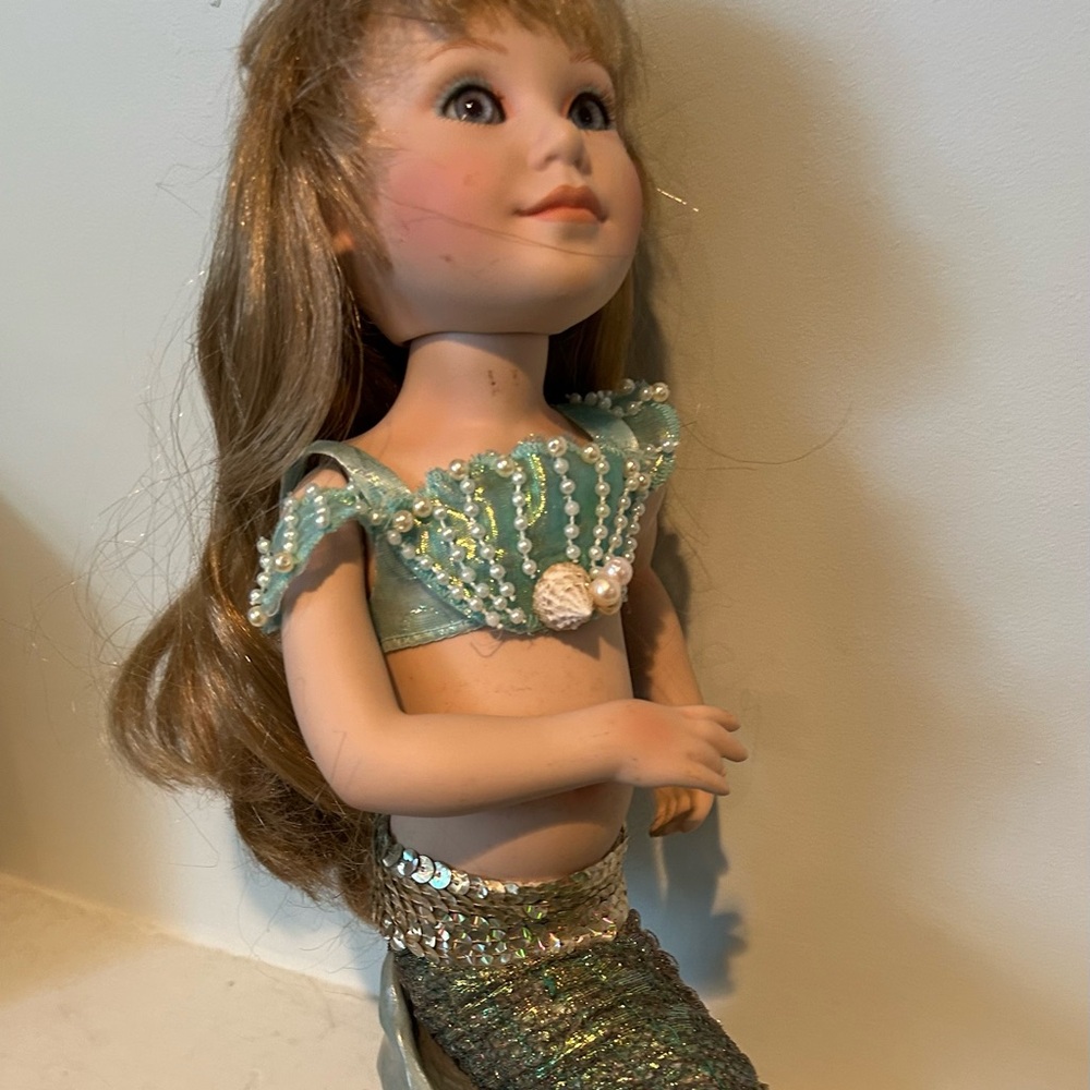 Mermaid Collectors Doll with cable arms, long blonde hair and resting base.